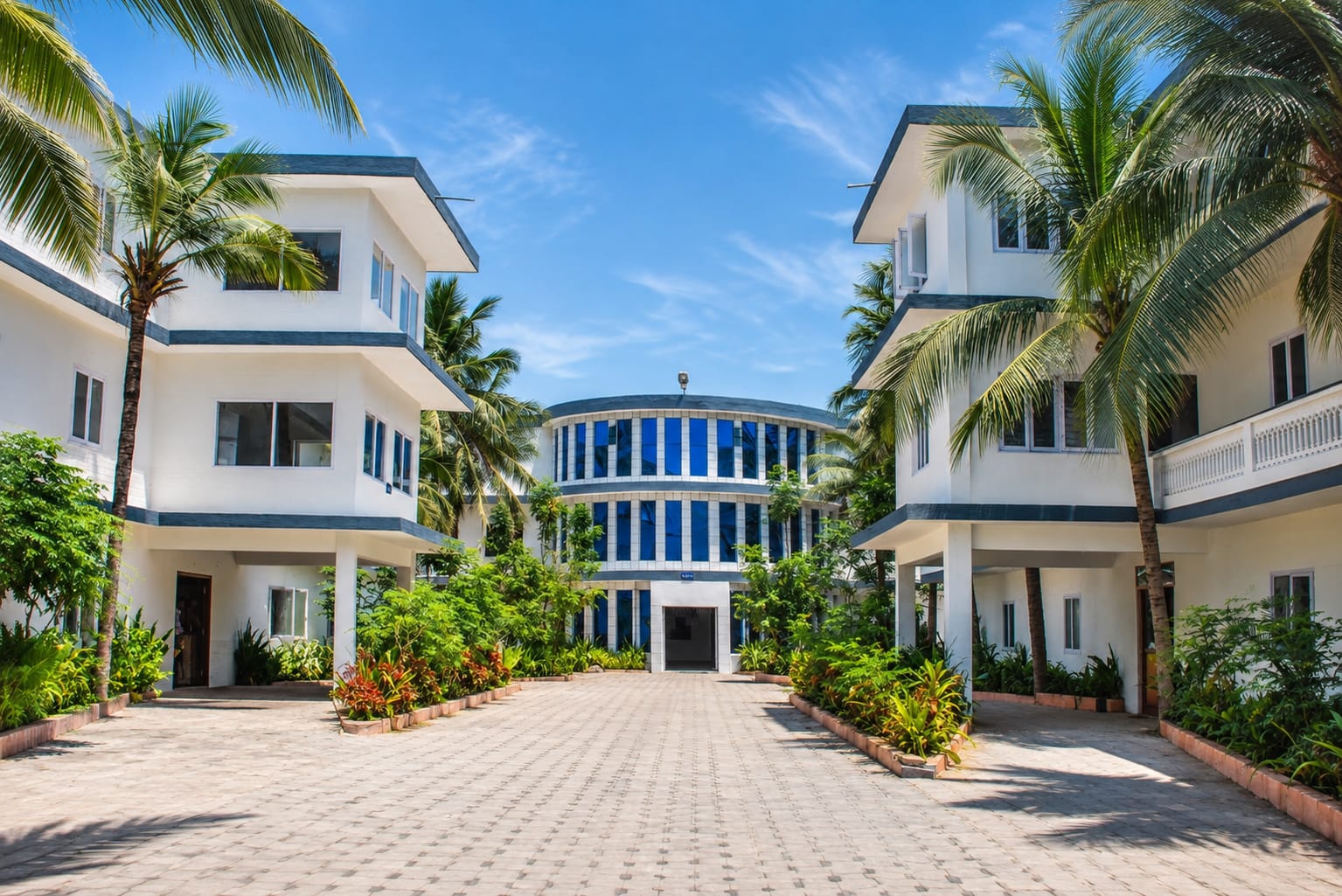 White multi-storey buildings around a paved courtyard